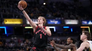 Toronto Raptors guard Gradey Dick, left, shoots in front of Indiana Pacers defenders Quenton Jackson, center, and Johnny Furphy, right, during the second half of an NBA basketball game in Indianapolis, Wednesday, Jan. 14, 2026. (AJ Mast/AP)