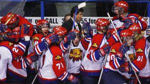 Moncton Wildcats coach Ted Nolan, centre, stands behind the bench as his team celebrates their 3-1 victory over the Vancouver Giants in the 2006 Memorial Cup semifinal. (Photo by Andrew Vaughan/CP)