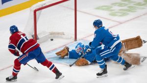 Montreal Canadiens' Nick Suzuki (14) scores on Colorado Avalanche goaltender Scott Wedgewood (41) as Avalanche's Cale Makar (8) skates in during first period NHL hockey action in Montreal on Thursday, Jan. 29, 2026. (Christinne Muschi/CP)