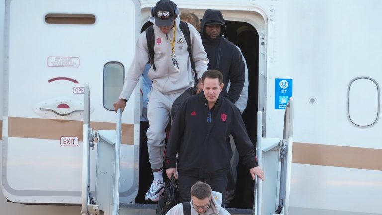Indiana head coach Curt Cignetti, walks off the plane after the team arrived at the Indianapolis International Airport in Indianapolis, Tuesday, Jan. 20, 2026. (Michael Conroy/AP)