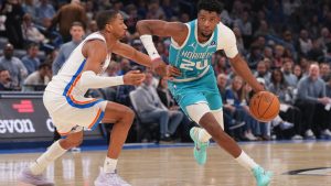 Charlotte Hornets forward Brandon Miller, right, drives past Oklahoma City Thunder guard Aaron Wiggins, left, during the second half of an NBA basketball game, Monday, Jan. 5, 2026, in Oklahoma City. (AP Photo/Kyle Phillips)