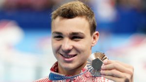 Canada's Ilya Kharun, of Montreal, poses with the bronze medal he won in the 100m men's butterfly final during the 2024 Summer Olympic Games, in Nanterre, France, Saturday, Aug. 3, 2024. (Christinne Muschi/CP)