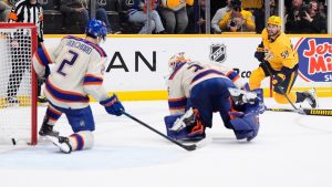 Nashville Predators defenceman Roman Josi scores the game winning goal past Edmonton Oilers defenceman Evan Bouchard and goaltender Tristan Jarry, center, in overtime of an NHL game Tuesday, Jan. 13, 2026, in Nashville, Tenn. (AP/George Walker IV)