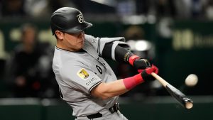 Yomiuri Giants' Kazuma Okamoto flies out in the fourth inning of a spring training baseball game against the Los Angeles Dodgers in Tokyo, Japan, Saturday, March 15, 2025. (Hiro Komae/AP)