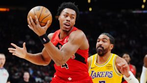 Toronto Raptors' Scottie Barnes (4) protects the ball from Los Angeles Lakers' Gabe Vincent (7) during first half NBA basketball action in Toronto on Thursday, Dec. 4, 2025. THE CANADIAN PRESS/Frank Gunn
