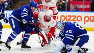Toronto Maple Leafs goaltender Joseph Woll makes a save as Jake McCabe defends against Detroit Red Wings' Dylan Larkin and James van Riemsdyk during first period NHL action in Toronto on Wednesday, Jan. 21, 2026. (THE CANADIAN PRESS/Frank Gunn)