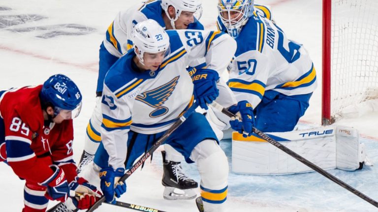 St. Louis Blues' Dylan Holloway, Logan Mailloux and goaltender Jordan Binnington defend against Montreal Canadiens' Alexandre Texier during second period NHL action, in Montreal on Sunday, Dec. 7, 2025. (THE CANADIAN PRESS/Christopher Katsarov)