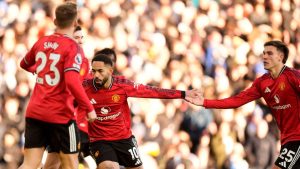 Manchester United's Matheus Cunha, center, celebrates after scoring his sides first goal during the English Premier League soccer match between Leeds United and Manchester United in Leeds, England, Sunday, Jan. 4, 2026. (Danny Lawson/PA via AP)