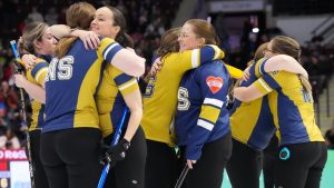 Curlers from the Nova Scotia-Black Nova Scotia-Stevens embrace after Christina Black's team beat Taylour Stevens team 11-6 at the Scotties Tournament of Hearts in Mississauga, Ont., Friday Jan. 30, 2026. (Chris Young/CP)