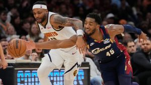 Cleveland Cavaliers guard Donovan Mitchell (45) steals the ball from Denver Nuggets guard Bruce Brown, left, in the second half of an NBA basketball game Friday, Jan. 2, 2026, in Cleveland. (Sue Ogrocki/AP)