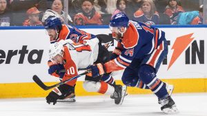 Philadelphia Flyers' Bobby Brink (10) is checked by Edmonton Oilers' Isaac Howard (53) and Mattias Ekholm (14) during first period NHL action, in Edmonton on Saturday, Jan. 3, 2026. (Jason Franson/CP)