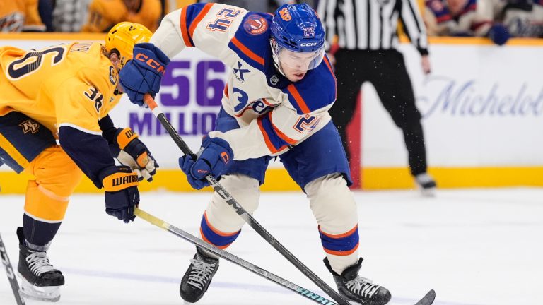 Edmonton Oilers defenceman Spencer Stastney (24) skates the puck past Nashville Predators left wing Cole Smith (36) during the first period of an NHL hockey game Tuesday, Jan. 13, 2026, in Nashville, Tenn. (George Walker IV/AP)