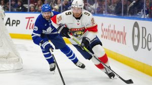 Florida Panthers' Sam Bennett (9) protects the puck from Toronto Maple Leafs' Oliver Ekman-Larsson (95) during first period NHL hockey action in Toronto on Tuesday, Jan. 6, 2026. THE CANADIAN PRESS/Frank Gunn