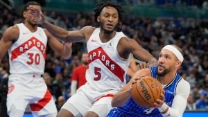Orlando Magic guard Jalen Suggs, right, pulls up after his path to the basket is blocked by Toronto Raptors guard Immanuel Quickley (5) during the first half of an NBA basketball game, Friday, Jan. 30, 2026, in Orlando, Fla. (John Raoux/AP)