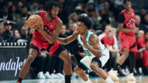 Toronto Raptors guard Immanuel Quickley (5) handles the ball against Charlotte Hornets guard Collin Sexton (8) during the second half of an NBA basketball game on Wednesday, Jan. 7, 2026, in Charlotte, N.C. (AP Photo/Krista Jasso)