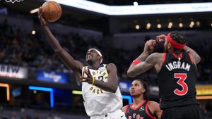 Indiana Pacers forward Pascal Siakam (43) shoots between Toronto Raptors defenders Collin Murray-Boyles (12) and Brandon Ingram (3) during the first half of an NBA basketball game in Indianapolis, Wednesday, Jan. 14, 2026. (AJ Mast/AP)