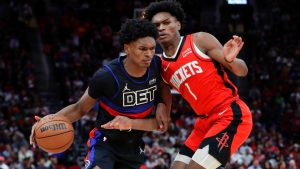 Detroit Pistons forward Ausar Thompson, left, drives against his twin brother, Houston Rockets forward Amen Thompson (1) during the second half of an NBA basketball game Monday, Jan. 1, 2024, in Houston. (AP Photo/Michael Wyke)
