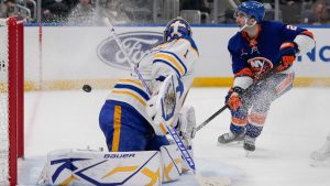 New York Islanders' Kyle Palmieri (21) shoots the puck past Buffalo Sabres goaltender Ukko-Pekka Luukkonen (1) for a goal during the second period of an NHL hockey game Monday, Dec. 23, 2024, in Elmont, N.Y. (AP Photo/Frank Franklin II)
