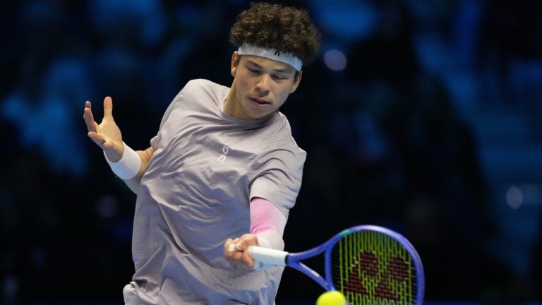 United States' Ben Shelton returns the ball to Italy's Jannik Sinner during their tennis match of the ATP World Tour Finals, in Turin, Italy, Friday, Nov. 14, 2025. (AP/Antonio Calanni)