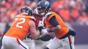 Denver Broncos quarterback Jarrett Stidham looks to hand off against the New England Patriots during the first half of the AFC Championship NFL game, Sunday, Jan. 25, 2026, in Denver. (AP/David Zalubowski)
