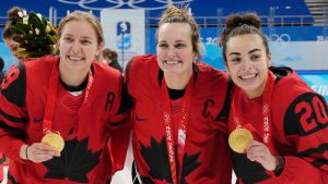 Team Canada's Brianne Jenner (19), Marie-Philip Poulin (29) and Sarah Nurse (20) celebrate with their gold medals after defeating the United States in women's hockey gold medal game action at the 2022 Winter Olympics in Beijing on Thursday, Feb. 17, 2022. (Ryan Remiorz/CP)
