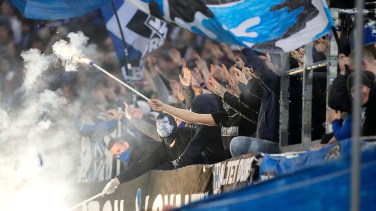Hamburg fans wave flags and use flares during the German Cup, semifinal soccer match between Hamburger SV and SC Freiburg in Hamburg, Germany, Tuesday, April 19, 2022. (Martin Meissner/AP)