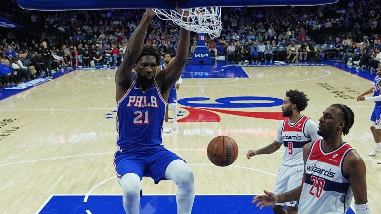 Philadelphia 76ers' Joel Embiid dunks against Washington Wizards' Alex Sarr during the first half of an NBA basketball game Wednesday, Jan. 7, 2026, in Philadelphia. (Matt Rourke/AP)