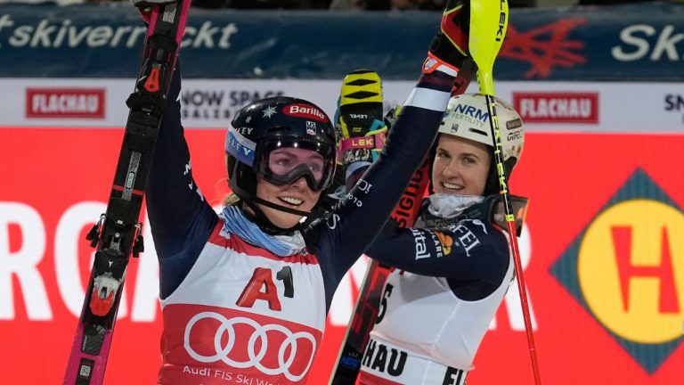 United States' Mikaela Shiffrin, left, celebrates with second placed United States' Paula Moltzan after winning an alpine ski, women's World Cup slalom, in Flachau, Austria, Tuesday, Jan. 13, 2026. (Giovanni Auletta/AP)