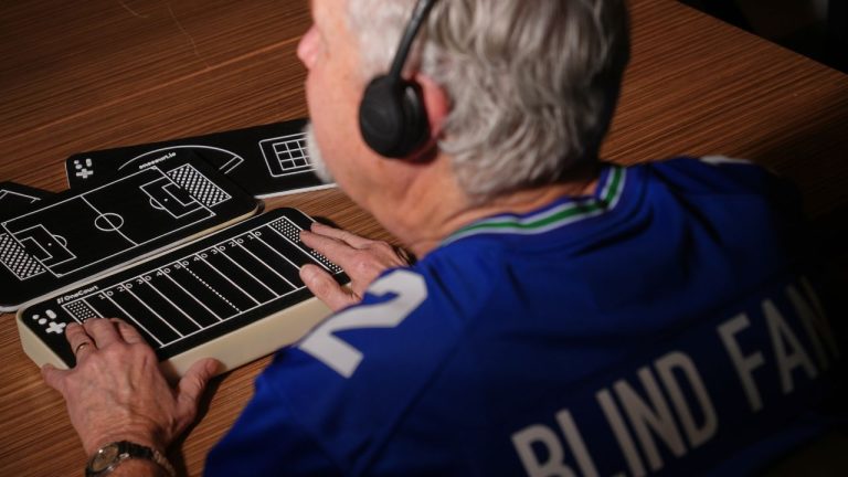 Clark Roberts, a blind Seattle Seahawks fan, uses a OneCourt tablet, a tactile device that translates gameplay into trackable vibrations along with real-time audio, at the T-Mobile Innovation Hub Tuesday, Jan. 27, 2026, in Bellevue, Wash. (Lindsey Wasson/AP)