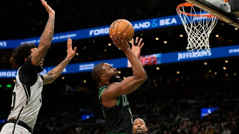 Boston Celtics guard Jaylen Brown (7) shoots while being defended by San Antonio Spurs forward Julian Champagnie (30) during the first half of an NBA basketball game Saturday, Jan. 10, 2026, in Boston. (AP Photo/Robert F. Bukaty)