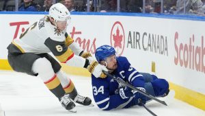 Vegas Golden Knights' Kaedan Korczak takes down Toronto Maple Leafs' Auston Matthews during second period NHL action in Toronto on Friday, Jan. 23, 2026. (CP/Nathan Denette)