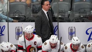 Ottawa Senators head coach Travis Green, centre top, looks on in the third period of an NHL game against the Colorado Avalanche, Thursday, Jan. 8, 2026, in Denver. (AP Photo/David Zalubowski)