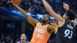 Cleveland Cavaliers guard Donovan Mitchell (45) goes to the basket past Orlando Magic forward Noah Penda (93) in the first half of an NBA basketball game in Cleveland, Monday, Jan. 26, 2026. (Sue Ogrocki/AP)