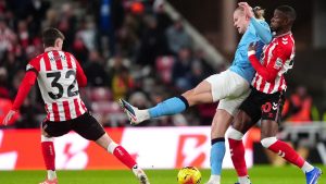 Manchester City's Erling Haaland and Sunderland's Nordi Mukiele, right, in action during the English Premier League soccer match between Sunderland and Manchester City in Sunderland, England, Thursday Jan. 1, 2026. (Owen Humphreys/AP)