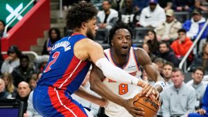 New York Knicks forward Og Anunoby, right, is pressured by Detroit Pistons guard Cade Cunningham, left, during the first half of an NBA game Monday, Jan. 5, 2026, in Detroit. (AP Photo/Ryan Sun)
