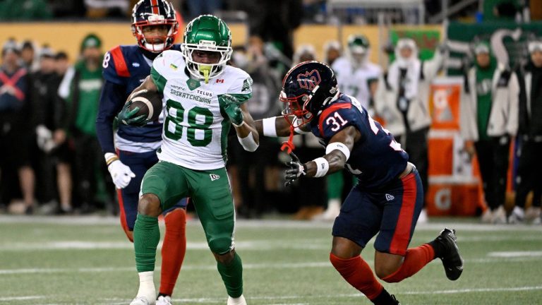Saskatchewan Roughriders' Dohnte Meyers (88) runs the ball under pressure from Montreal Alouettes' Robert Kennedy III (31) during first half CFL football action at the 112th Grey Cup, in Winnipeg on Sunday, Nov. 16, 2025. (Fred Greenslade/THE CANADIAN PRESS)