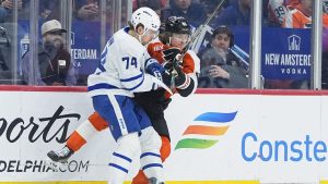 Toronto Maple Leafs' Bobby McMann (74) collides with Philadelphia Flyers' Trevor Zegras during the first period of an NHL game, Thursday, Jan. 8, 2026, in Philadelphia. (AP Photo/Matt Rourke)