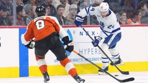 Toronto Maple Leafs' Scott Laughton (24) tries to pass past Philadelphia Flyers' Cam York during the first period of an NHL hockey game, Thursday, Jan. 8, 2026, in Philadelphia. (AP Photo/Matt Rourke)