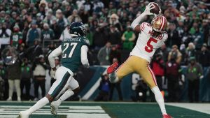 San Francisco 49ers wide receiver Demarcus Robinson pulls in a pass to sore touchdown in front of Philadelphia Eagles cornerback Quinyon Mitchell during NFL wild-card playoff game Sunday, Jan. 11, 2026, in Philadelphia. (AP Photo/Matt Rourke)