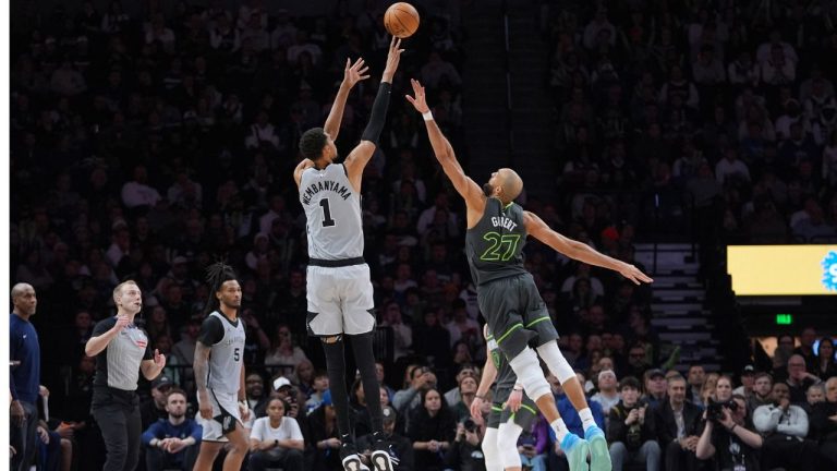 San Antonio Spurs forward Victor Wembanyama (1) shoots over Minnesota Timberwolves center Rudy Gobert (27) during the second half of an NBA basketball game, Sunday, Jan. 11, 2026, in Minneapolis. (AP Photo/Abbie Parr)