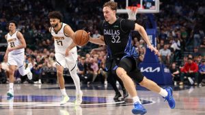 Dallas Mavericks forward Cooper Flagg (32) brings the ball up the court during the third quarter of an NBA basketball game against the Denver Nuggets Tuesday, Dec. 23, 2025, in Dallas. (Sam Hodde/AP)