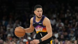 Phoenix Suns guard Devin Booker dribbles the ball against the New York Knicks during the second half of an NBA game, Friday, Jan. 9, 2026, in Phoenix. (AP Photo/Ross D. Franklin)
