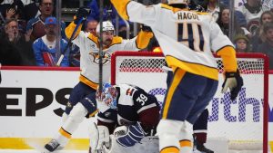 Nashville Predators defenseman Nicolas Hague (41) and left wing Filip Forsberg, back left, celebrate after a goal by centre Ryan O'Reilly (not shown) past Colorado Avalanche goaltender MacKenzie Blackwood (39) in the first period of an NHL game Friday, Jan. 16, 2026, in Denver. (AP Photo/David Zalubowski)