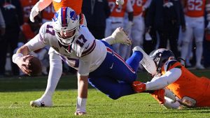 Buffalo Bills quarterback Josh Allen (17) is tackled by Denver Broncos safety Talanoa Hufanga during the first half of an NFL divisional round playoff football game, Saturday, Jan. 17, 2026, in Pittsburgh. (David Zalubowski/AP)
