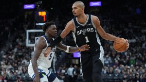 San Antonio Spurs forward Victor Wembanyama (1) drives against Minnesota Timberwolves guard Anthony Edwards (5) during the second half of an NBA basketball game in San Antonio, Saturday, Jan. 17, 2026. (Eric Gay/AP)