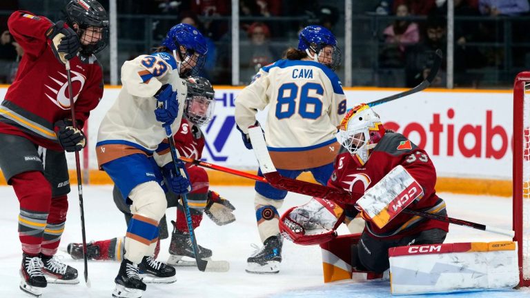 Ottawa Charge goaltender Gwyneth Philips (33) looks for the save in front of Vancouver Goldeneyes' Michelle Karvinen (33) and Michela Cava (86) during second period PWHL hockey action in Ottawa, on Wednesday, Nov. 26, 2025. (Justin Tang/CP)