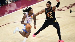 Oklahoma City Thunder guard Cason Wallace, left, drives against Cleveland Cavaliers guard Donovan Mitchell, right, in the first half of an NBA basketball game, Monday, Jan. 19, 2026, in Cleveland. (David Dermer/AP)