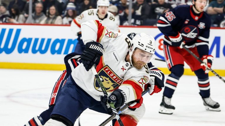 Winnipeg Jets' Dylan DeMelo (2) defends against Florida Panthers' Sam Bennett (9) during first period NHL action in Winnipeg, Thursday, January 22, 2026. (John Woods/CP)