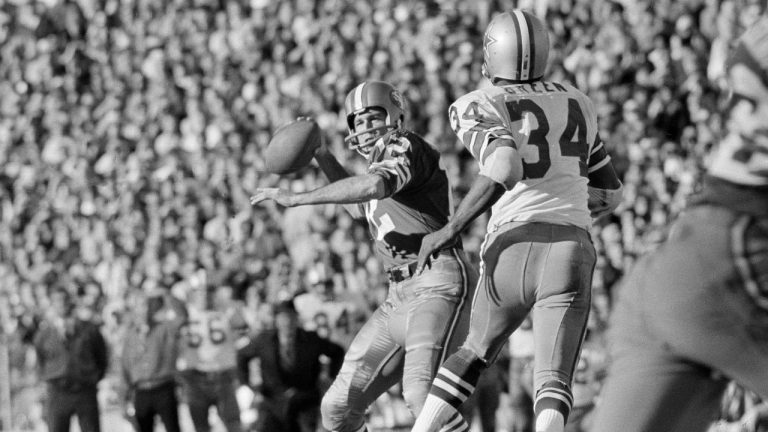 San Francisco 49ers quarterback John Brodie looks to pass as Dallas Cowboys' Cornell Green (34) defends during the NFC championship game in San Francisco, Jan. 3, 1971. In the first meeting at Kezar Stadium in San Francisco, Dallas used 143 yards rushing and a TD from Duane Thomas and two interceptions of John Brodie to win 17-10. (AP Photo/File)