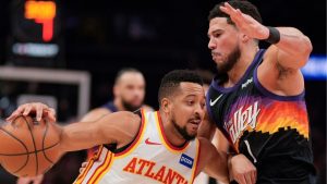 Atlanta Hawks guard CJ McCollum (3) drives against Phoenix Suns guard Devin Booker (1) during the first half of an NBA basketball game, Friday, Jan. 23, 2026, in Atlanta. (AP Photo/Mike Stewart)